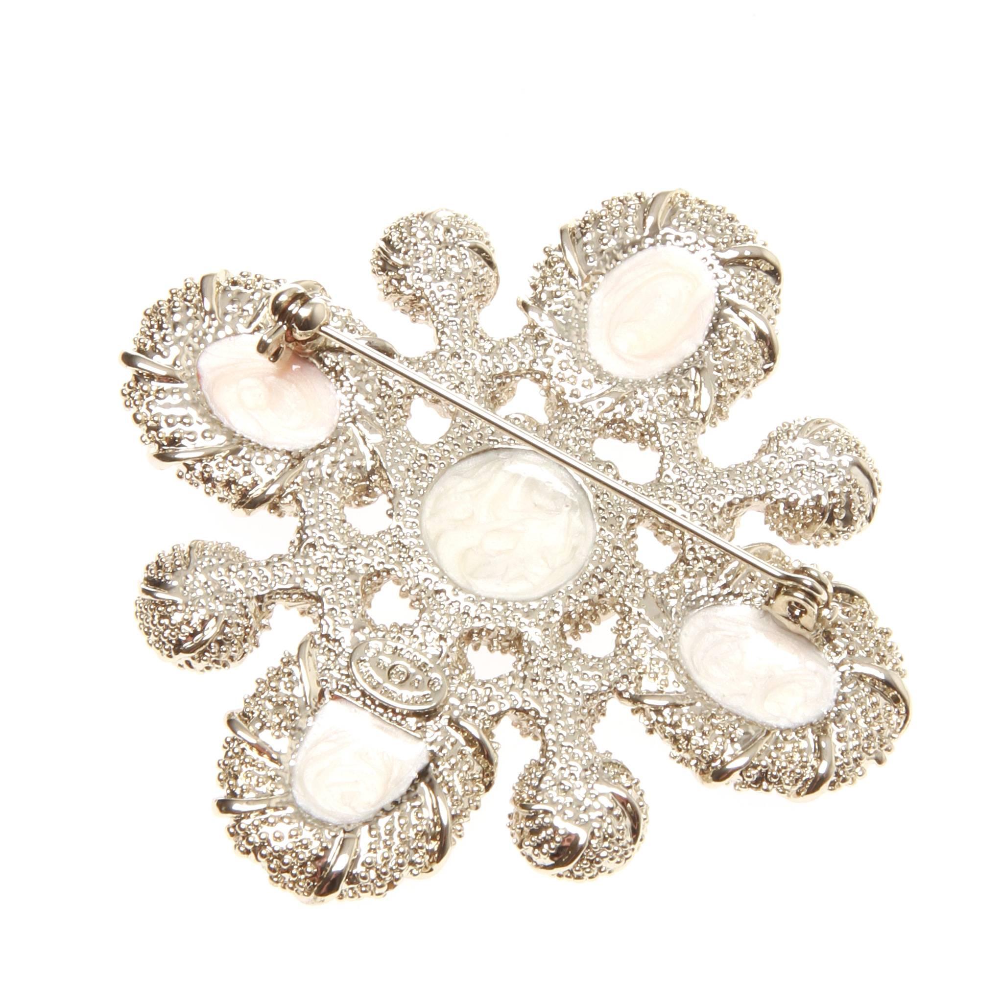 Chanel CC brooch marked 12 A (Autumn 2012) and featuring a beautiful carnelian, pearl look and Swarovski crystal accented silver-tone design. 

Roll pin fastening at back. Comes with original and authentic box. 
