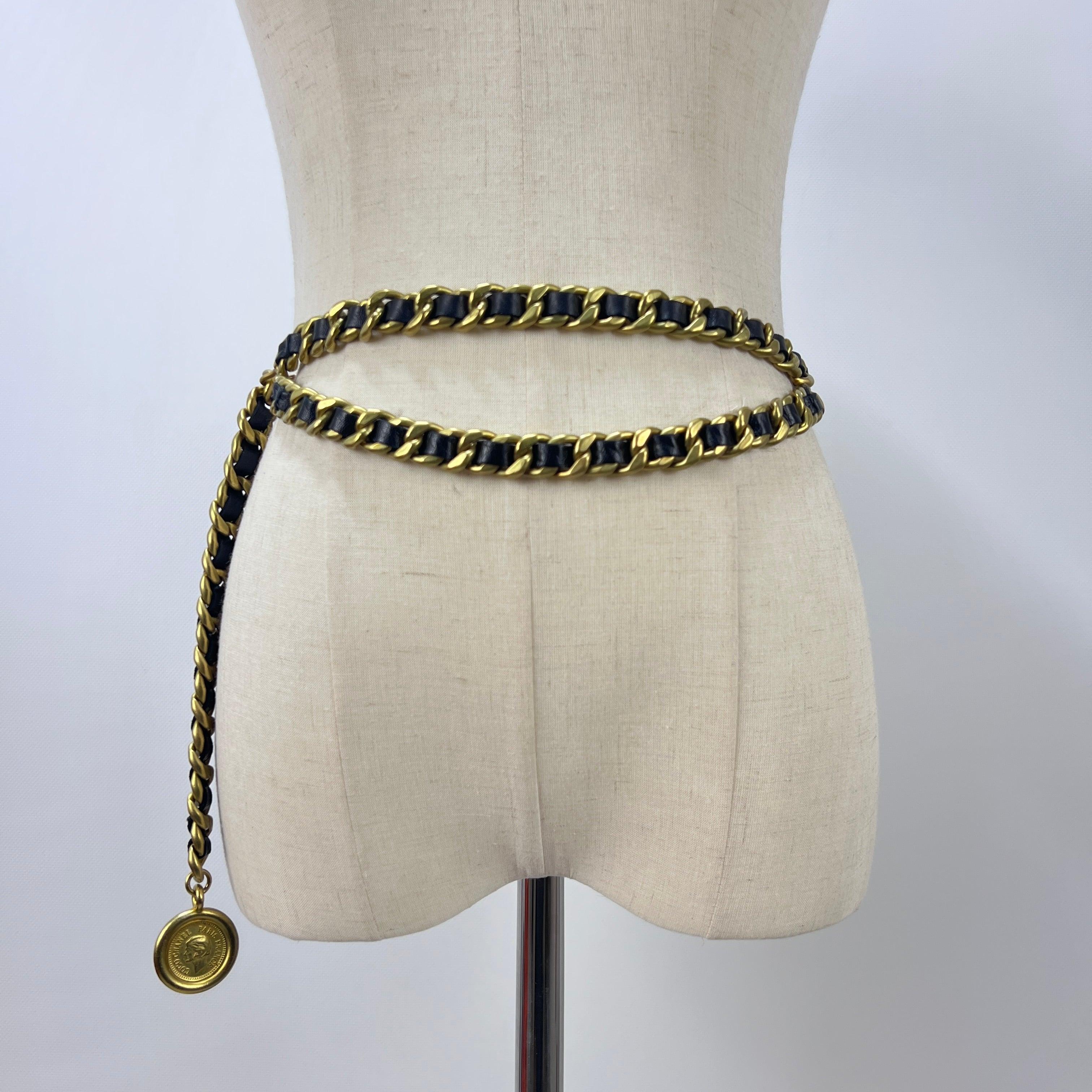 Magnifique ceinture CHANEL CC Chaîne entrelacée en métal doré et cuir noir, issue de la collection Automne 1994 sous la direction artistique de Karl Lagerfeld. Cette période marque l'apogée du style CHANEL des années 1990 : silhouettes sculpturales,