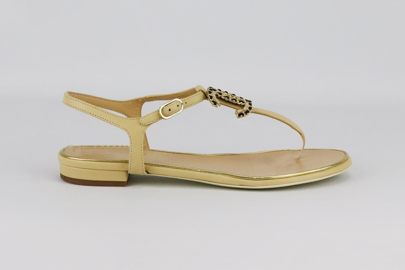 Chanel 2014 CC chain detailed leather sandals. Beige, gold and black. Buckle fastening at back. Does not come with box or dustbag. Size: EU 38 (UK 5, US 8). Insole: 9.4 in. Heel: 0.5 in
