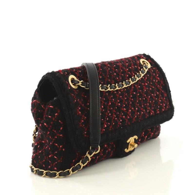 This Chanel CC Chain Flap Bag Knit Fabric Medium, crafted in black and pink printed knit fabric, features woven-in leather chain strap and aged matte gold-tone hardware. Its CC turn-lock closure opens to a pink fabric interior with side zip pocket.