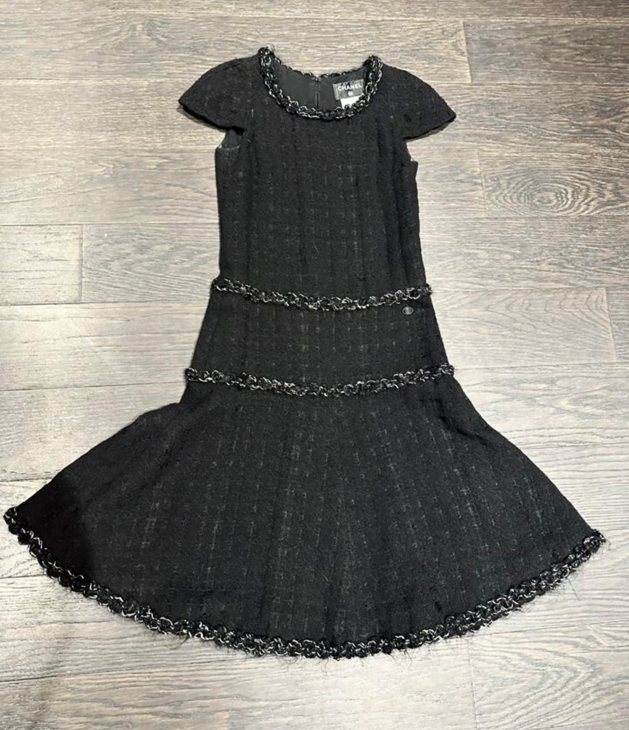 Absolutely timeless Chanel little black tweed dress with CC logo charm at waist.
Unmistakably 'CHANEL' silhouette
- black silk lining
Size mark 34 FR. Condition is pristine, no signs of wear.