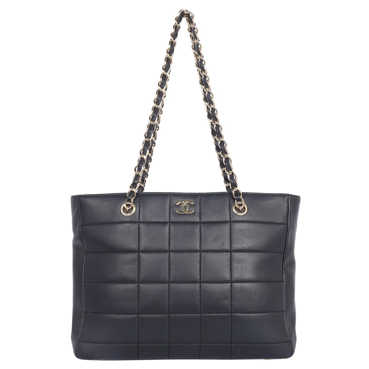 Authentic, pre-loved vintage Chanel black classic Choco Bar CC shoulder bag tote. Black was Coco's happiest color and it's displayed in every Chanel collection. Features lambskin black leather, this Chanel shoulder bag has a quilted pattern with a