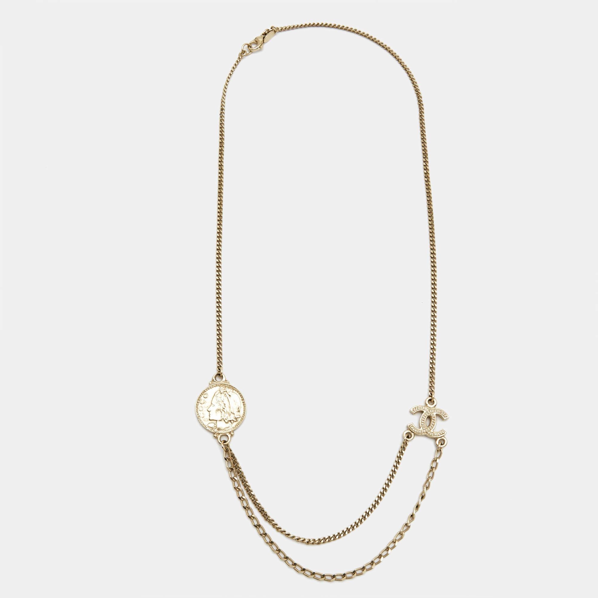 The Chanel CC Coco necklace is an exquisite piece of jewelry. It features a gold-tone chain with the iconic Chanel logo, the double 'C' interlocking design, and Coco Chanel's profile. This timeless necklace adds a touch of elegance and luxury to any