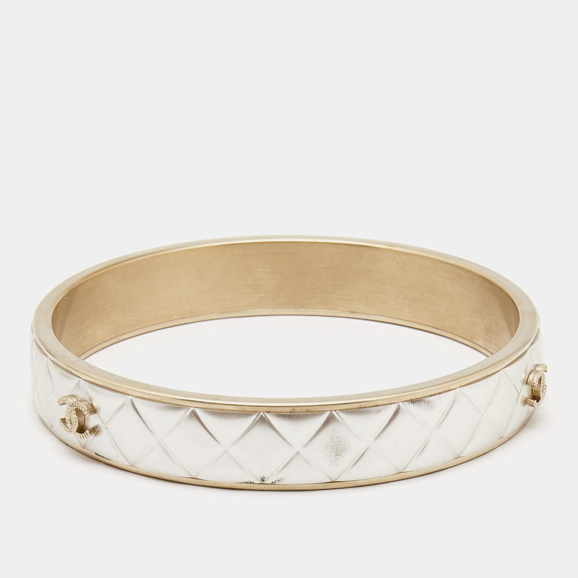 The Chanel CC bracelet is a stunning fashion accessory. Crafted with exquisite attention to detail, it features the iconic CC logo in a composite design, set against a quilted backdrop. This bracelet exudes luxury and sophistication, making it a