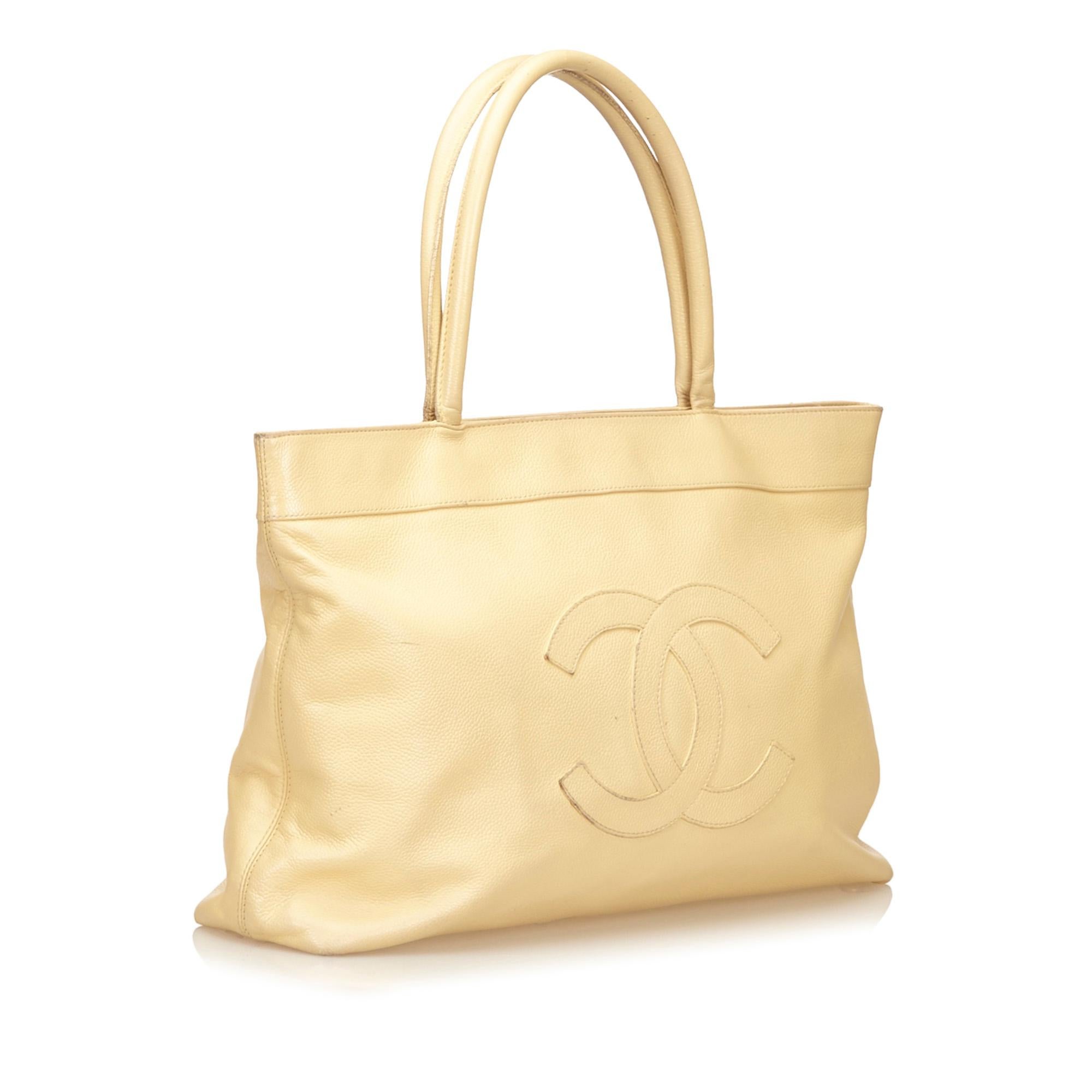 Chanel CC Cream Caviar Leather Tote Bag

This tote features a caviar leather body with embossed interlocking Cs, rolled handles, top magnetic closures, and interior zip and open pockets.

Please note, these items are pre-owned and may show signs of
