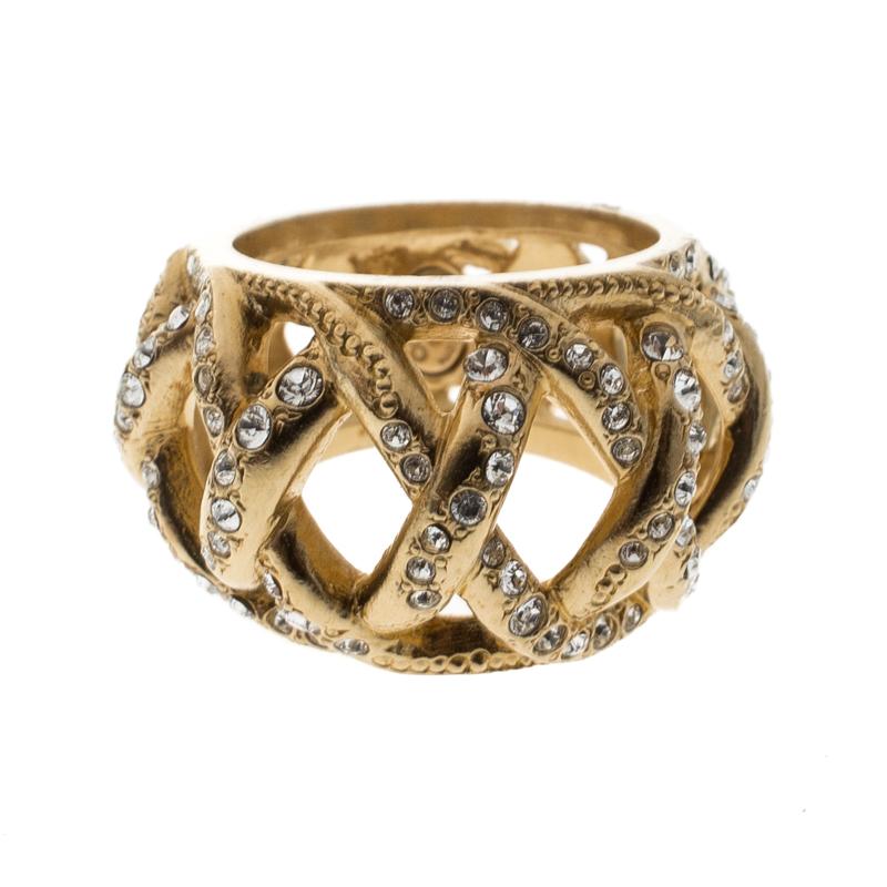 Easy-going, chic and classy, there is no reason to not like this Chanel ring. Featuring a band silhouette, this piece comes with a gold-tone body with crisscross pattern decked with crystals all around. It exudes an antique appearance that looks