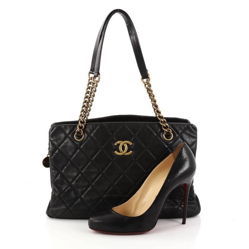 This authentic Chanel CC Crown Tote Quilted Leather Medium mixes chic style with vintage-inspired detailing. Crafted in black quilted leather, this chic tote features aged gold chain straps with leather pads, protective base studs and center CC