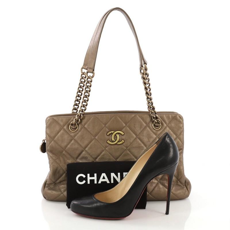 This Chanel CC Crown Tote Quilted Leather Medium, crafted from gold quilted leather, features chain straps with leather pads, protective base studs and aged gold-tone hardware. It opens to a beige fabric interior divided into two open compartments