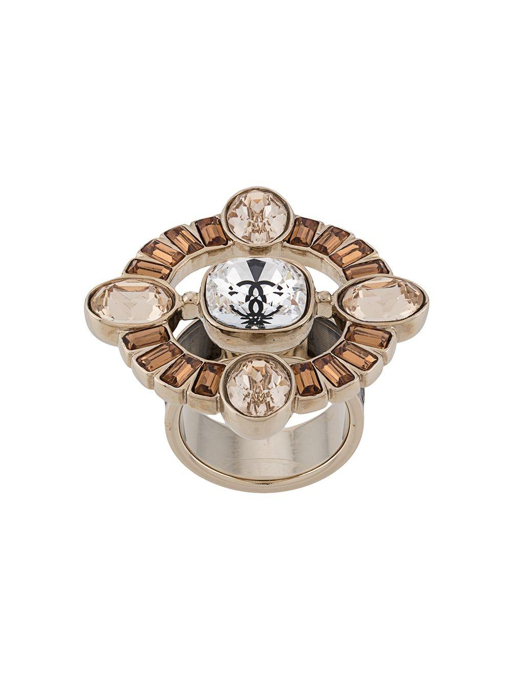 Crafted in France from gold-plated metal, this ornate vintage ring from Chanel features an elegant circular design, crystal embellishments arranged into the shape of the iconic maltese cross and the brand's signature interlocking CC logo in the