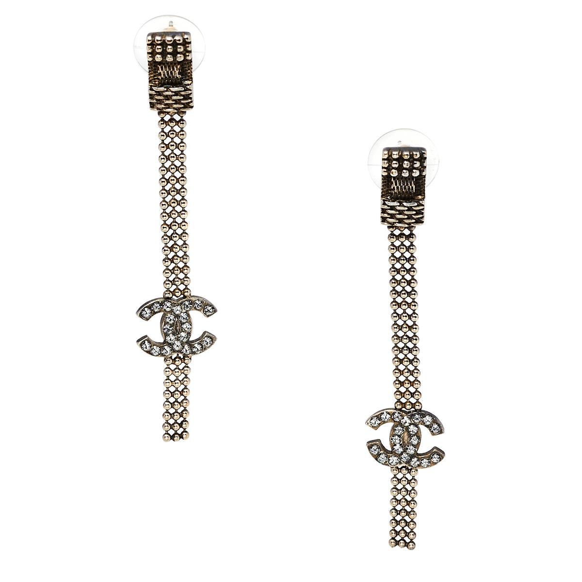 Chanel's elegant charm is evident in this pair of gold-tone chain tassel earrings. Detailed with a crystal-embellished CC logo on the tassels, these earrings are complete with pushback fastening.

