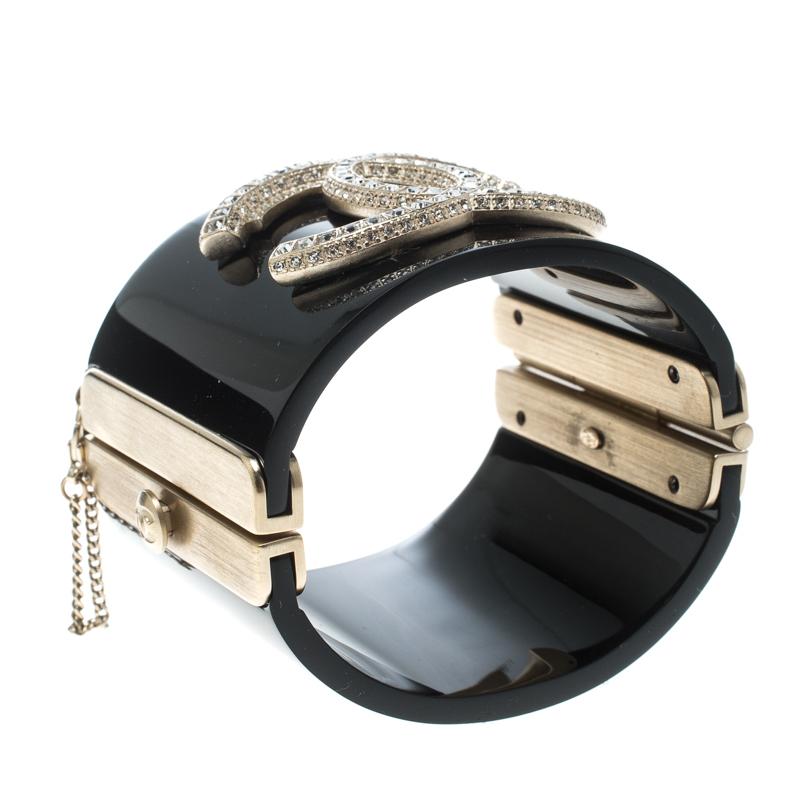 This marvellously designed cuff bracelet by Chanel is so pretty you'll love having it on your wrist. The resin creation has been designed with a large CC logo of crystals and gold-tone metal fittings.

Includes: Original Box
