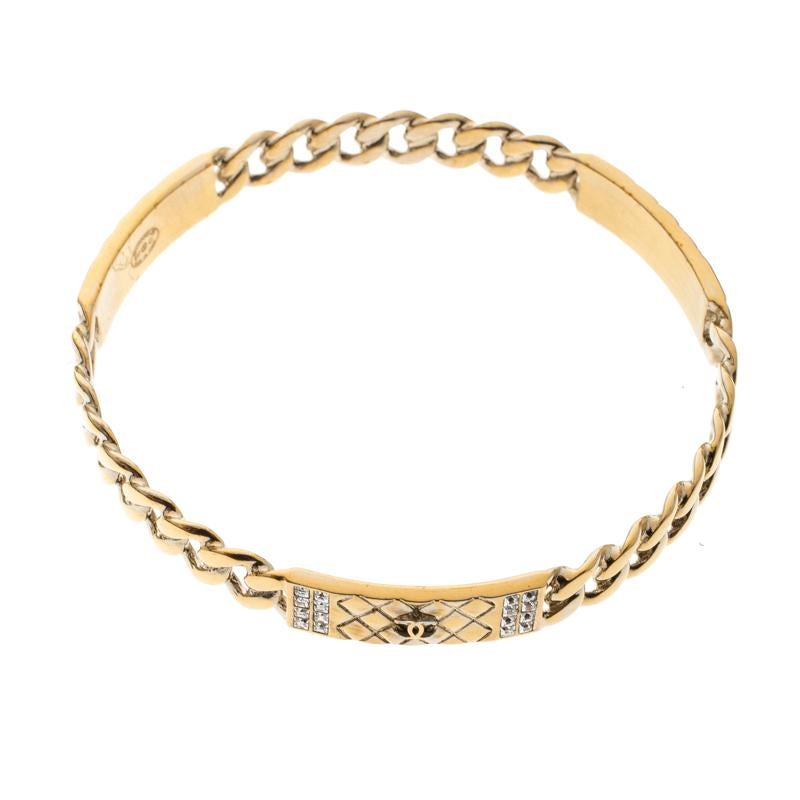 Beautifully sculpted from gold-tone metal, this Chanel bangle bracelet is a choice of a modern woman. It carries a design of crystals, quilts and the CC logo. This bracelet is classy and a prized buy.

Includes: Original Box, Price Tag
