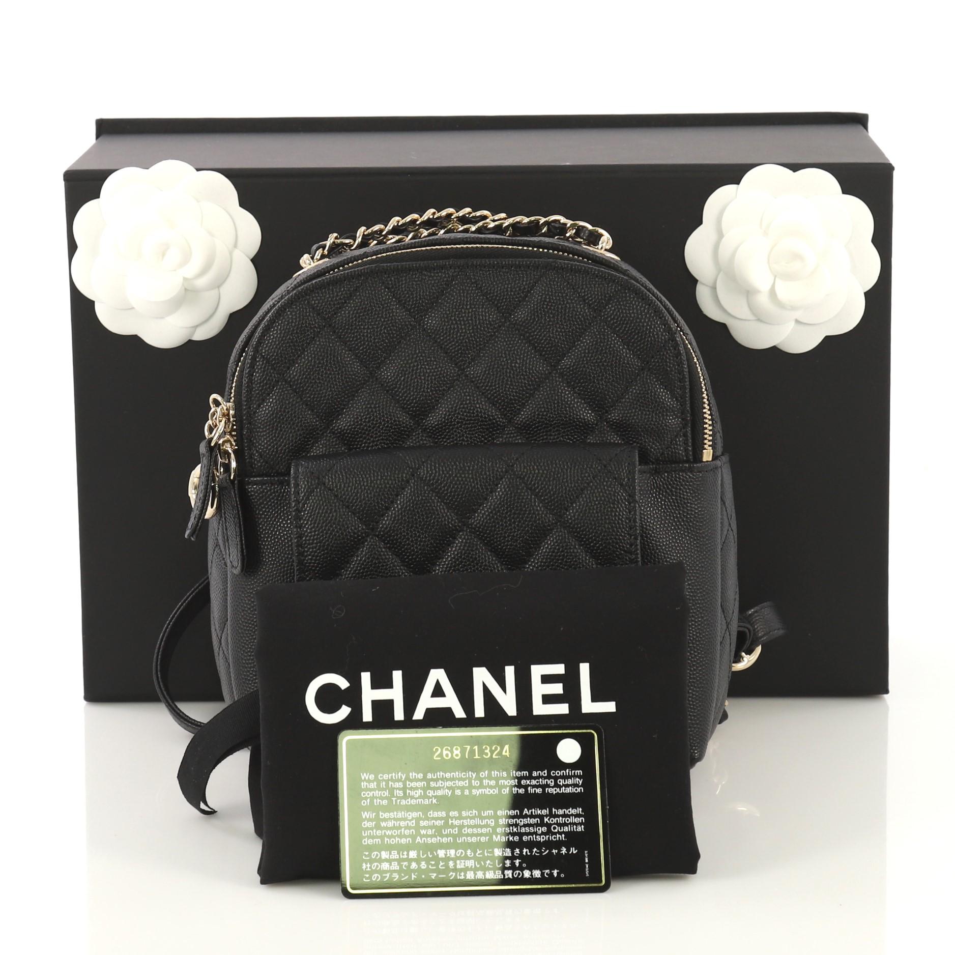 This Chanel CC Day Backpack Quilted Caviar Mini, crafted from black quilted caviar, features front flap pocket with CC turn-lock closure, adjustable backpack straps, and gold-tone hardware. Its zip closure opens to a black fabric interior with slip