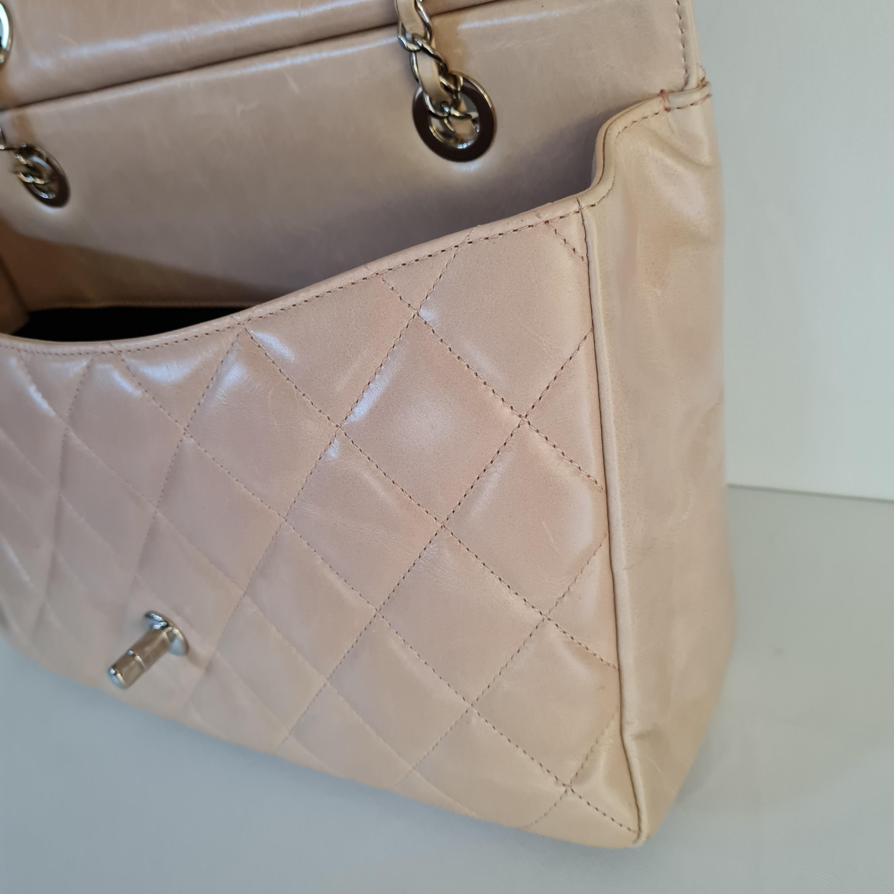 Chanel CC Delivery Tote bag is a shopping tote which features the signature quilted calfskin leather. Unique top handle with Chanel logo engraved. Light beige color with plexiglass handle. 

Jumbo size, 2 ways to carry.

Inclusion: Dust Bag

Serial