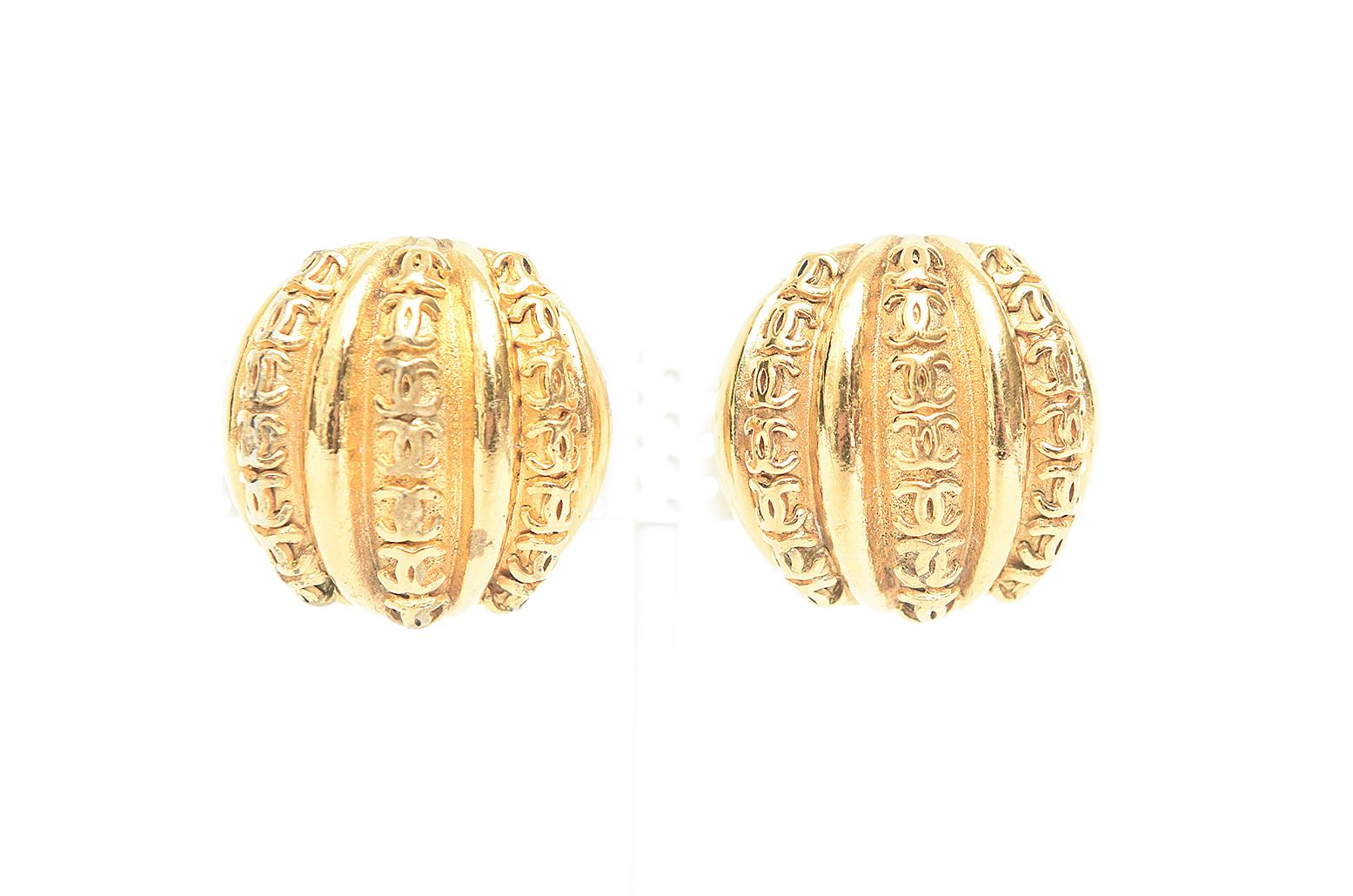 These unusual pair of Chanel and iconic clip on earrings look like melons or ridged domes with abundant cc's all over the top. It is gilt metal. These are from season 23 which is 1983 when Karl Lagerfeld became creative director and Victoire De