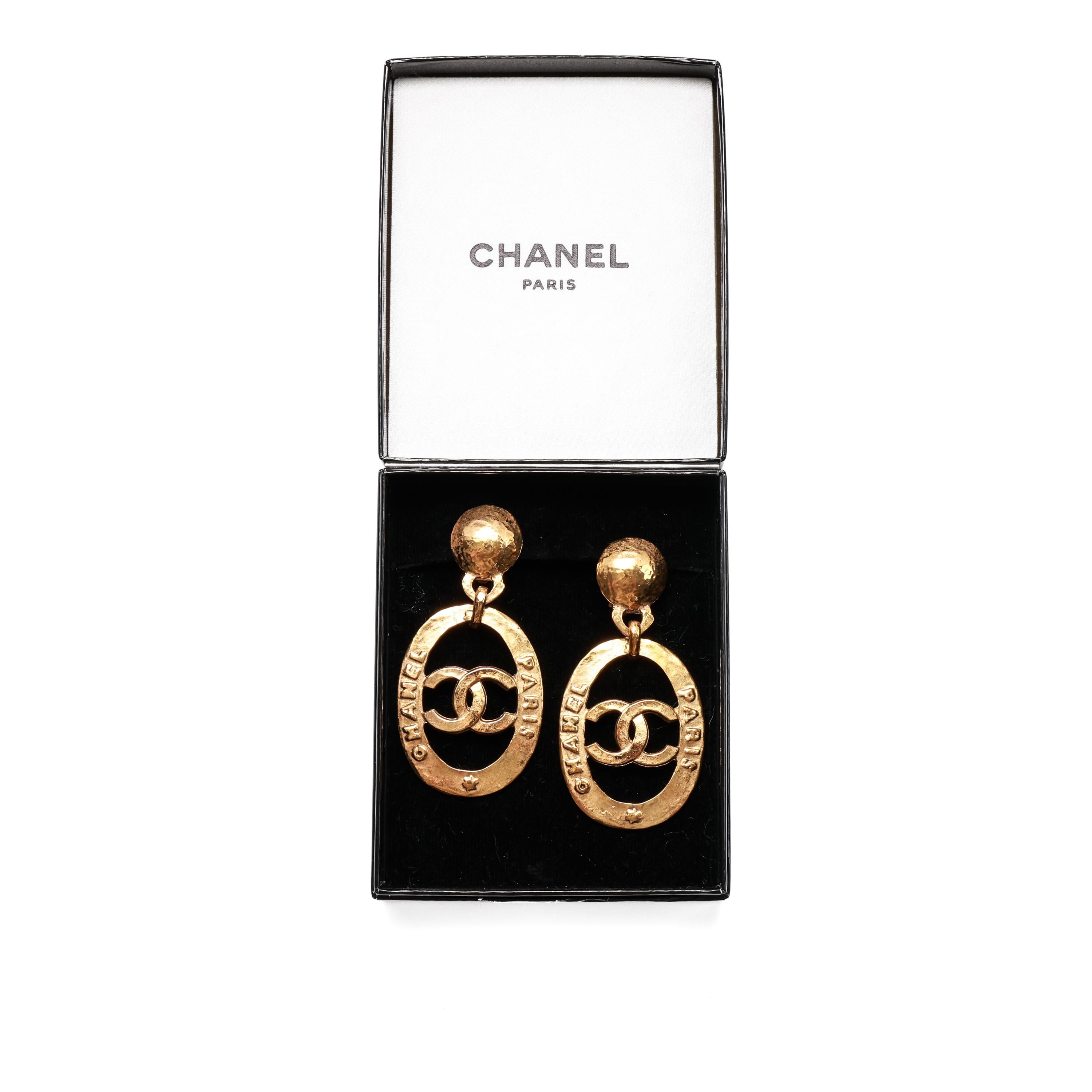 These mint condition gold-tone CC Chanel Doorknocker clip-on earrings from France (except for the pads attached to the ear clips) show no signs of wear. They come in their original Chanel box, original receipt (which is so faded you can barely make