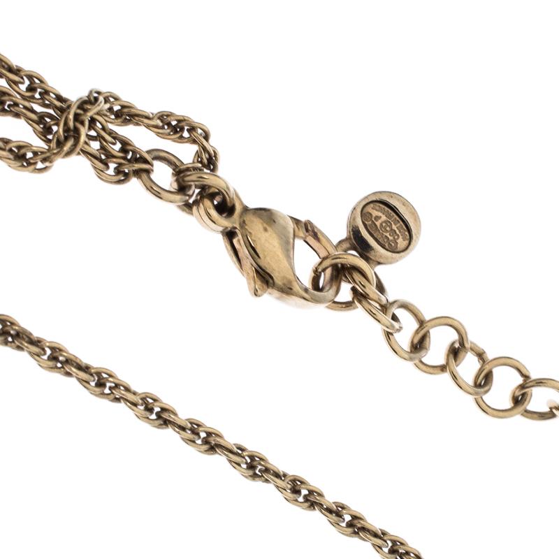 This Chanel piece is a beauty to behold. It has been crafted out of gold-tone metal and styled in a dual strand of chains holding beads and CC logos enhanced with enamel. It is complete with a lobster-clasp closure. This necklace will enhance all