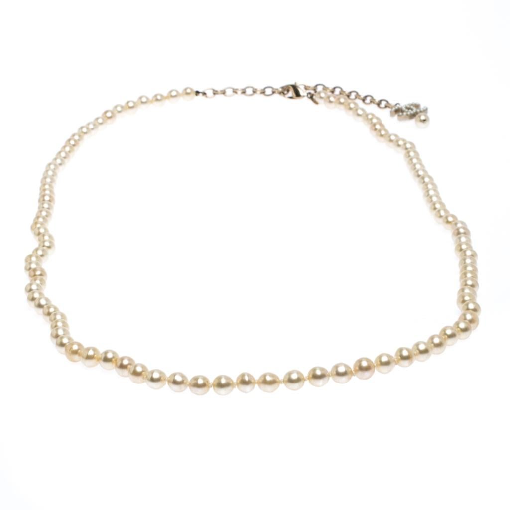This long necklace from Chanel is sure to catch an eye and make your heart skip a beat. The necklace is designed with gold-tone metal, faux pearls and secured by a lobster clasp. It can be used as a necklace and as a belt too.

Includes: Original