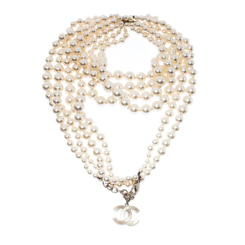 Crafted out of gold-tone metal, this flawless necklace by Chanel can be your next prized possession. The design involves multiple strands of faux pearls that will sit around your neck and essay the beauty that Chanel holds. The piece is held by a