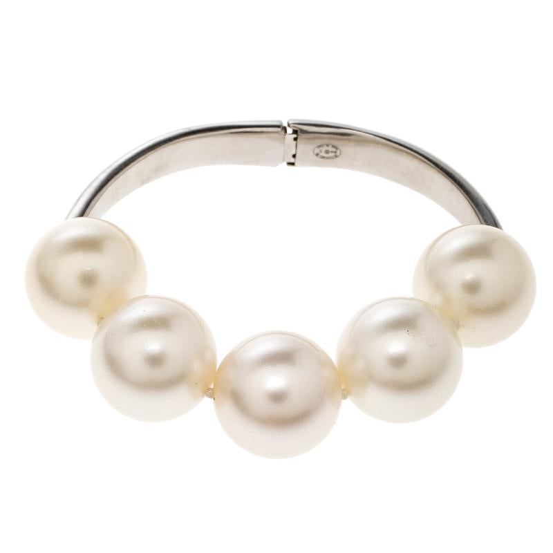 Pearls add a touch of sophistication to any look. This Chanel bracelet is designed in a silver-tone metal and detailed with cream faux pearl on the top. Style it with a coordinating neckpiece for weddings or celebratory occasions.

Includes: