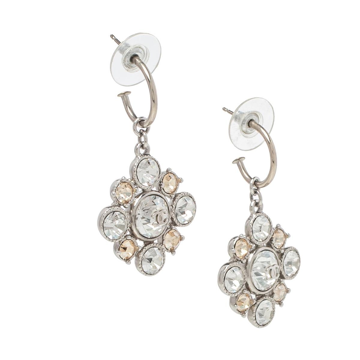 These earrings from Chanel are so pretty, you'll love flaunting them for your most special outings! Crafted from silver-tone metal, these hoop earrings have a floral-shaped drop that is beautifully embellished with crystals along with the iconic CC