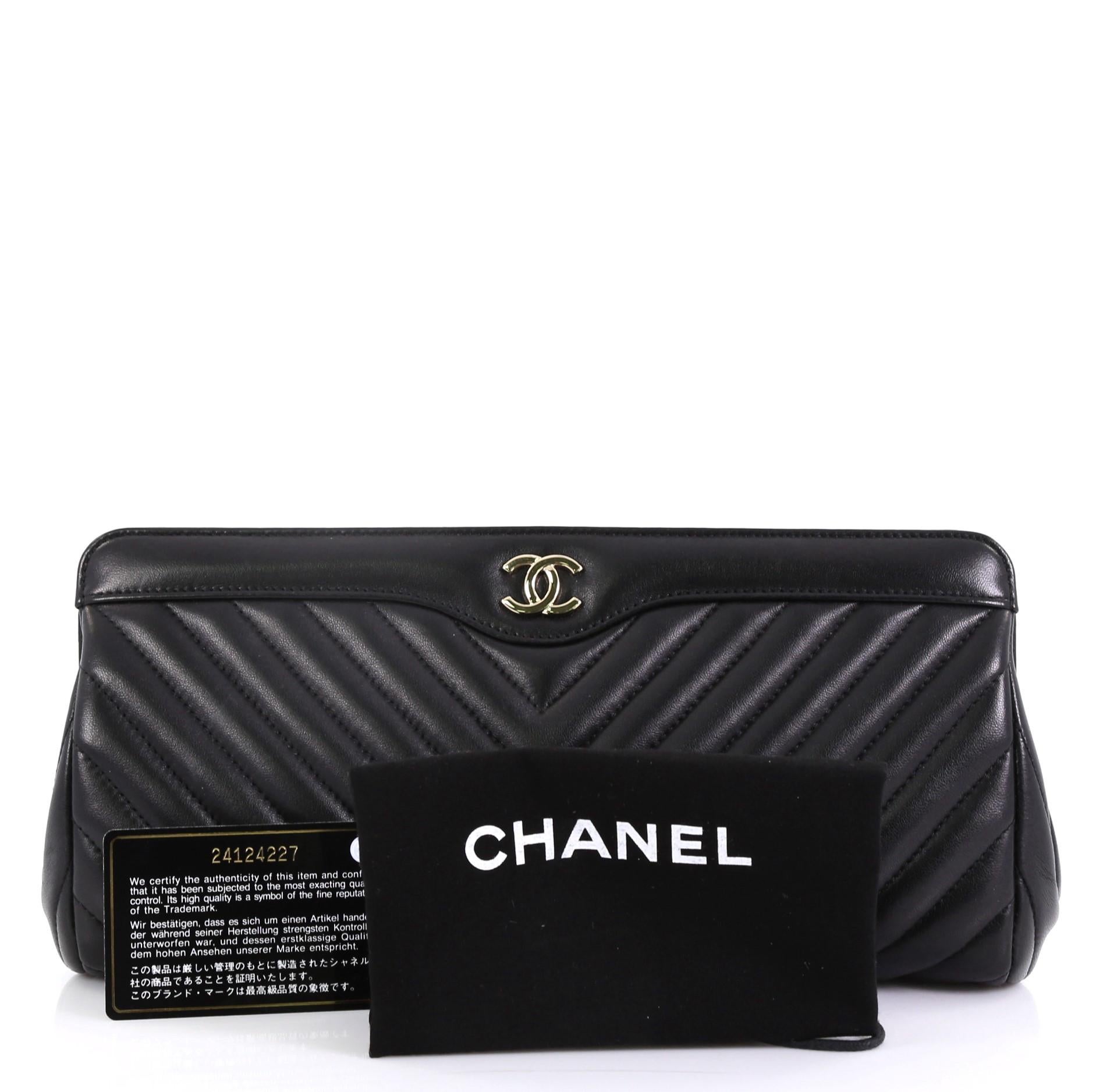 This Chanel CC Frame Clutch Chevron Lambskin, crafted from black chevron lambskin leather, features framed top and gold-tone hardware. Its magnetic snap button closure opens to a black leather interior with side zip pocket. Authenticity code reads: