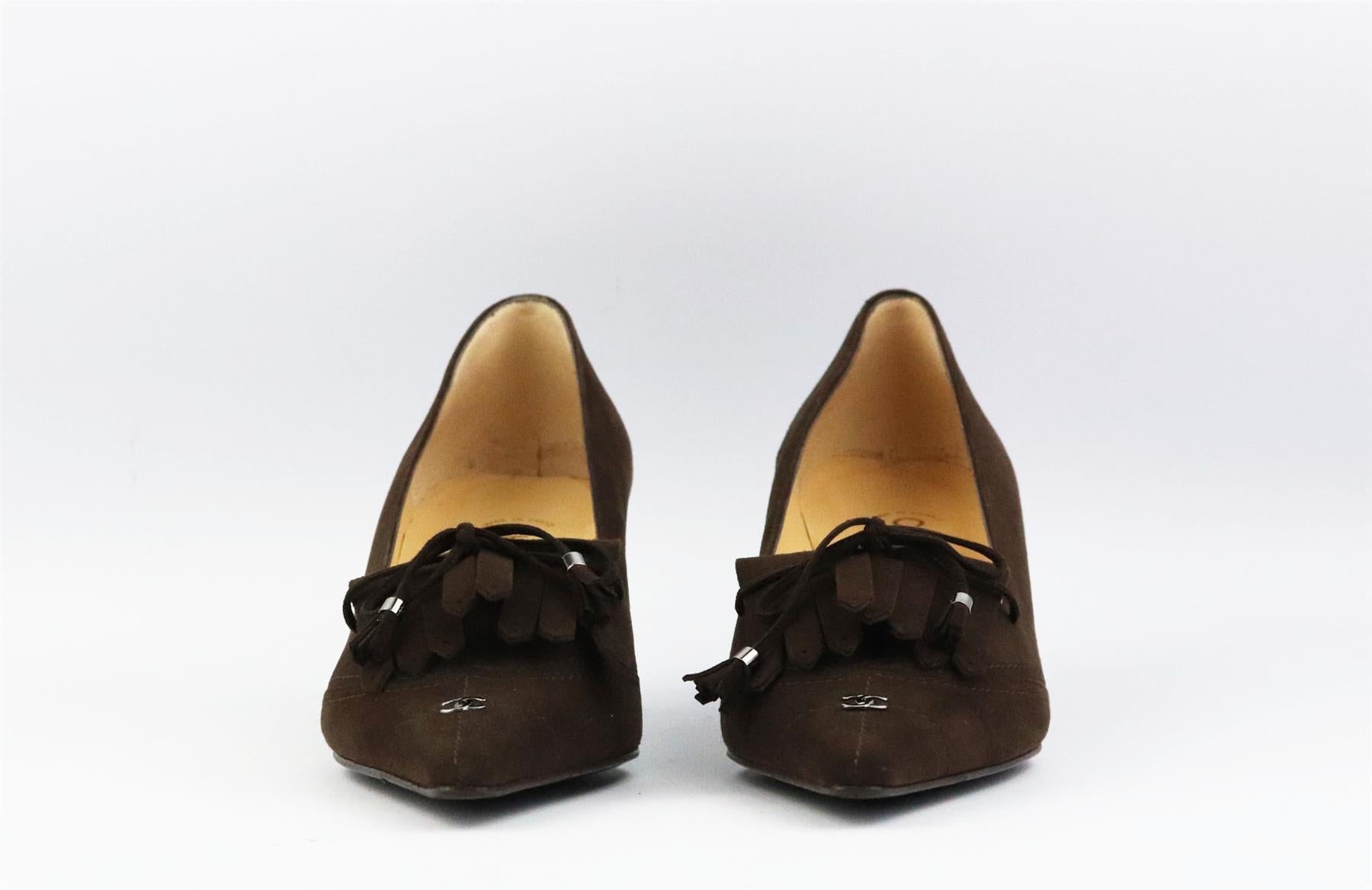 These vintage pumps by Chanel have been made in Italy from brown suede, they're set on a small structured wooden heel that's balanced with a pointed toe and CC tassel and fringe detail. Heel measures approximately 50 mm/ 2 inches. Brown suede. Slip