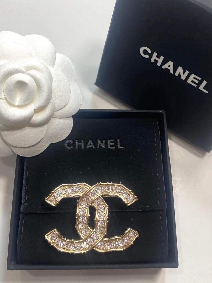 Chanel CC Gold And Crystal Brooch. CC stamp in back. Made in Italy. There are several crystals within the CC that provide a great shine to the entire area.

Measurements approximately:
Length-1.5 inches , Width - 2 inches 
