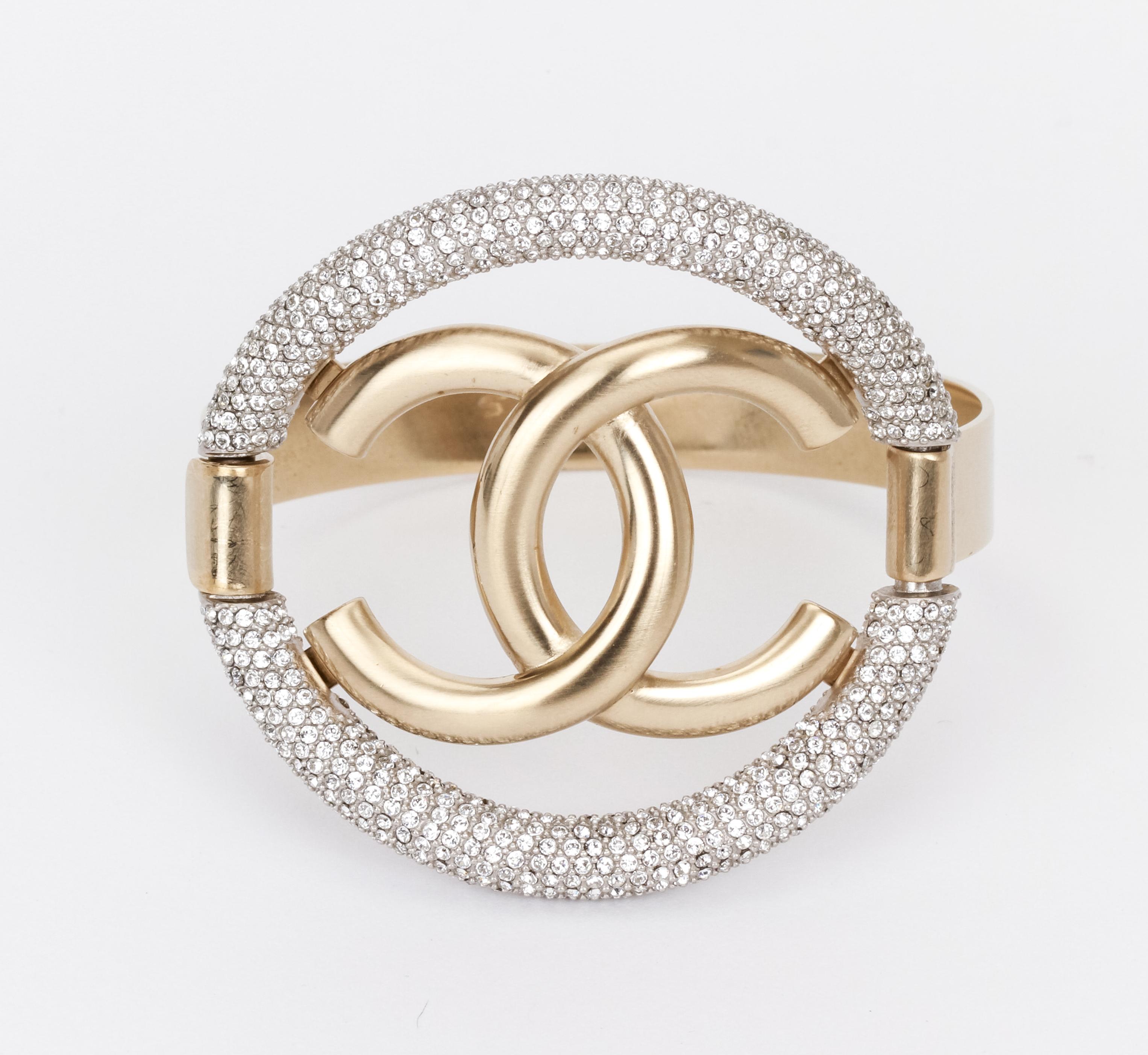 Stunning Chanel bracelet in light gold with interlocking CC logo surrounded in a circle of sparkling rhinestones. Comes with original pouch.