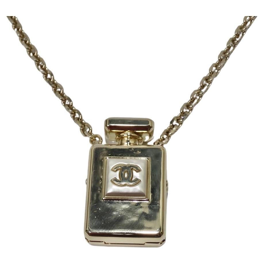 Do not miss out on this brand new 2022 Chanel locket style necklace with the most stunning iconic Chanel perfume bottle pendent! A beautiful white gold is complimented by a pearly white motif with signature Chanel interlocking 'C' logo at the