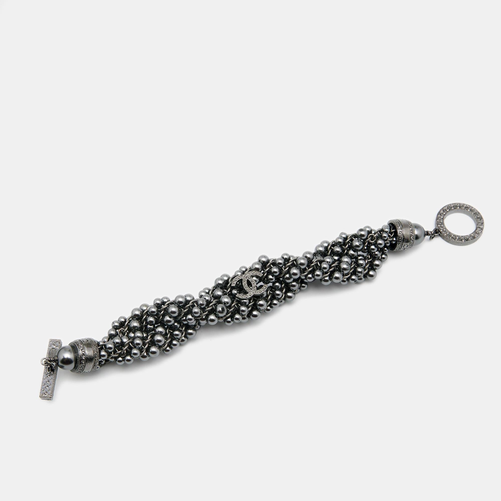 Studded with faux pearls, this gunmetal-tone bracelet from the house of Chanel is a must-have for anyone who loves to keep it simple, feminine, and classy. It comes with a CC logo embellishment. We love how the pearls reflect and add a touch of