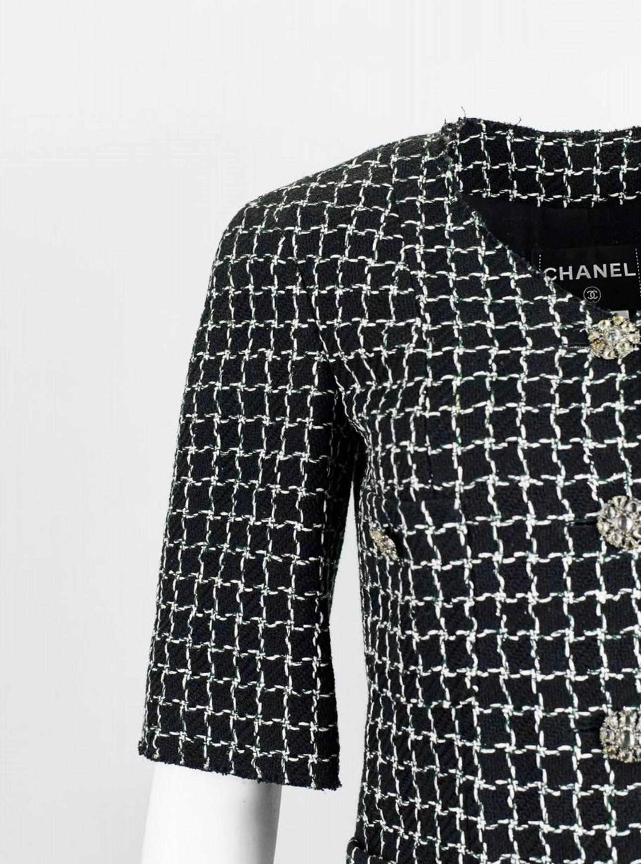 Timeless Chanel black tweed jacket with check pattern and CC logo jewel Gripoix buttons -- from Ad Campaign of 2013 Pre Spring Collection -- as seen on model Stella Tennant.
- black silk lining
Size mark 36 FR. Pristine condition.