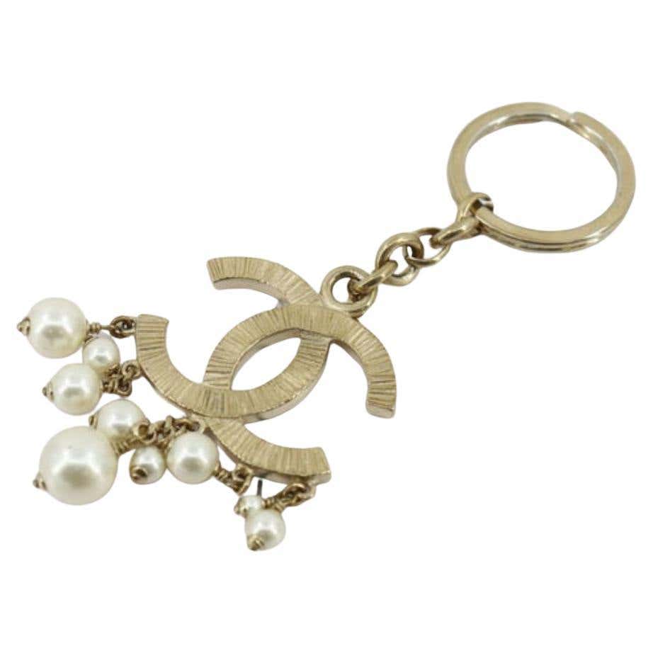 Chanel CC key chain is crafted in light gold-tone hardware and features ...