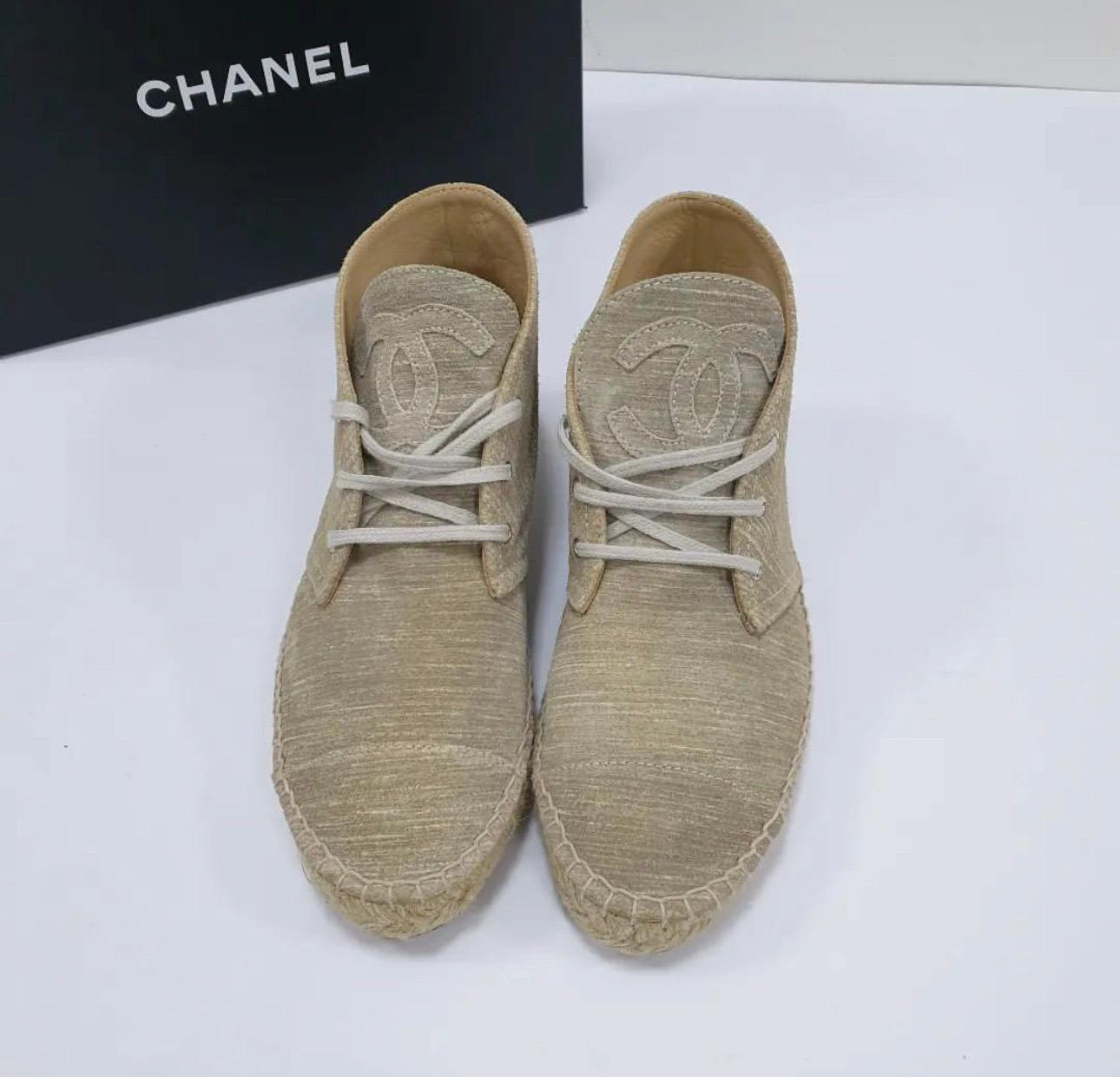 Chanel's lace-up espadrilles in cream linen, featuring the brand's trademark interlocking CC logo on the tongue in a matching frayed cream linen, they have a thick jute sole and a reinforced canvas toe which offers a comfortable and supportive