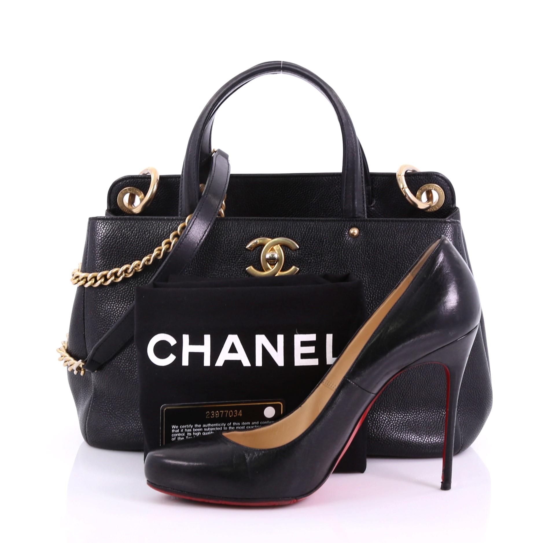 This Chanel CC Lock Shopping Tote Caviar Small, crafted in black caviar leather, features dual top handles and gold-tone hardware. Its CC turn lock closure opens to a black fabric interior with zip and slip pockets. Hologram sticker reads: 23977034.