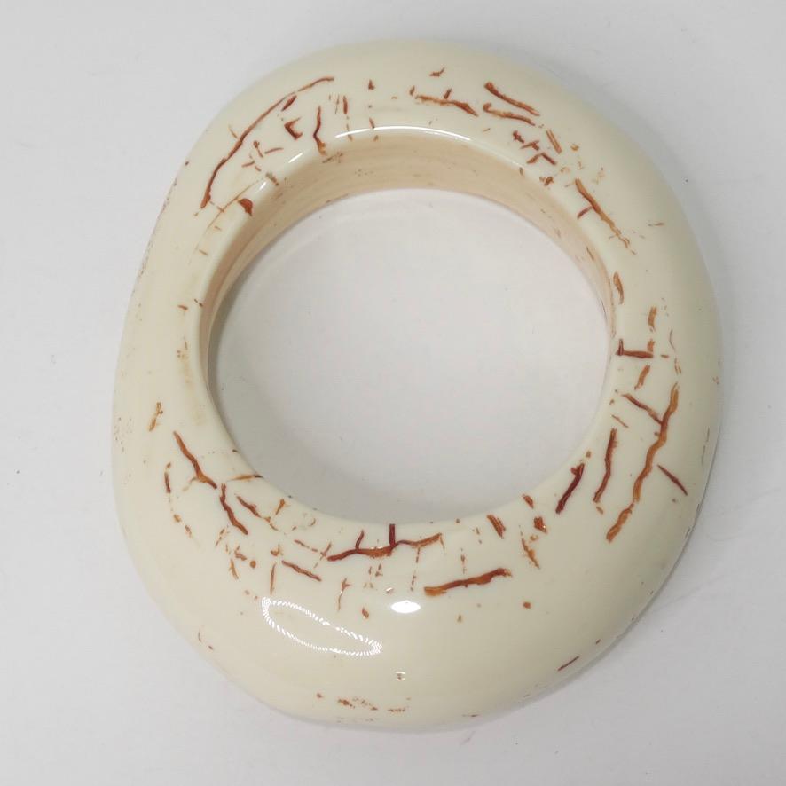 Do not miss out on this super unique large Chanel bangle bracelet circa 2000! Made of resin color is ivory-cream featuring a brown classic double 'C' Chanel logo in the center and brown etching motifs. This bracelet purposefully has a very vintage