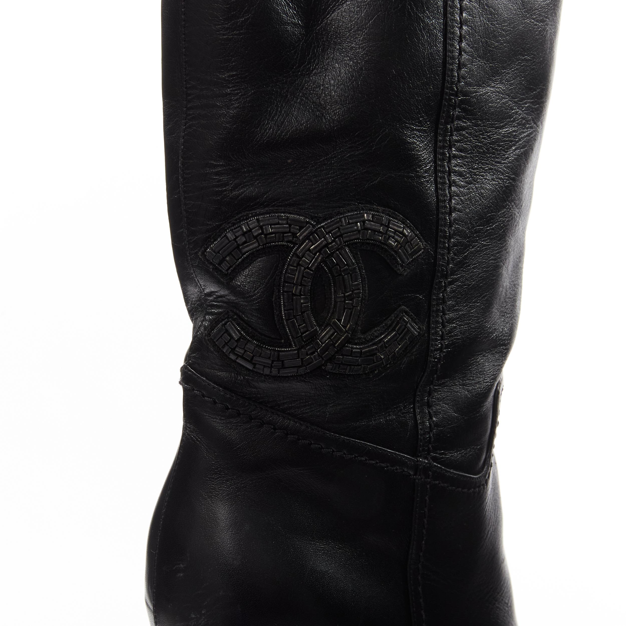 CHANEL CC logo bead embellishment black leather wedge heeled boots EU38
Reference: GIYG/A00274
Brand: Chanel
Designer: Karl Lagerfeld
Material: Leather
Color: Black
Pattern: Solid
Closure: Pull On
Lining: Black Fabric
Made in: