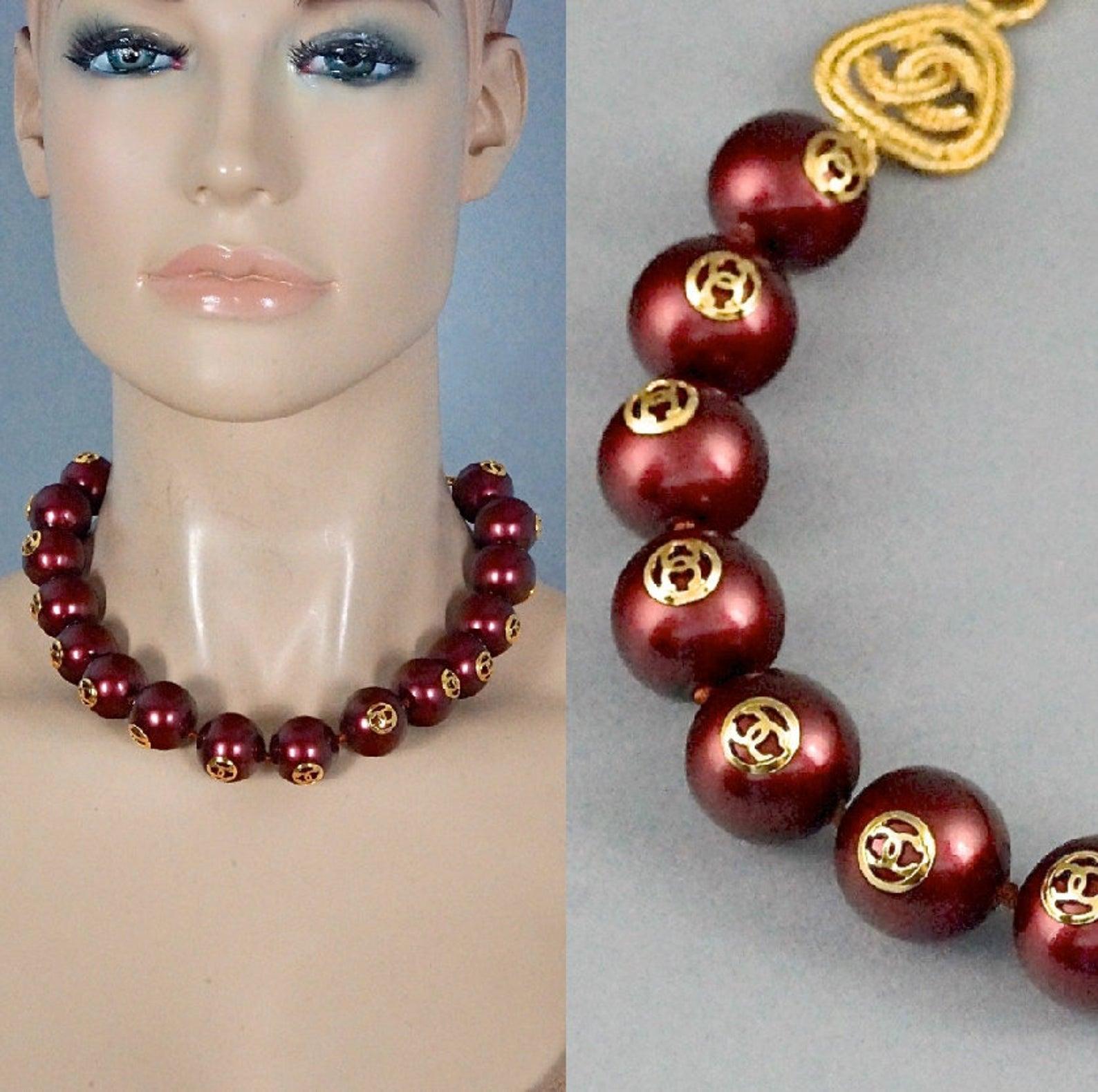 Features:
- 100% Authentic CHANEL.
- Single strand bordeaux glass pearl necklace.
- Each pearl has CC metal logo.
- Adjustable hook closure.
- Signed CHANEL 2 CC 8 Made in France on the oval plate.
- Gold tone hardware.
- Excellent vintage