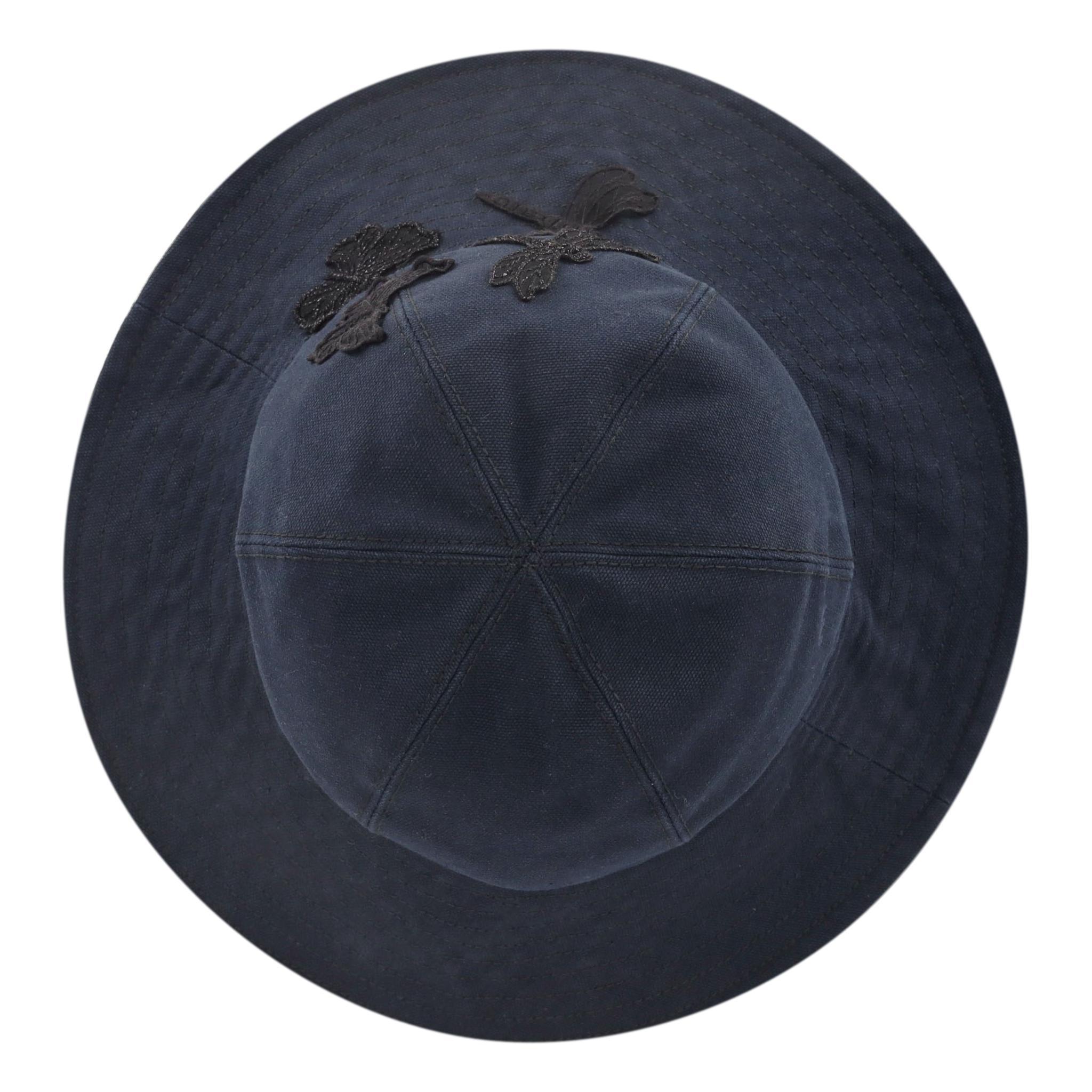 Chanel 'CC' Logo Butterfly Embellished Cotton Hat

Navy blue hat designed with black butterfly and dragonfly adornments accented with lace and sparkling silver threads.

Featuring black 'CC' logo detail and satin lined interior.

Rrp Approx.
