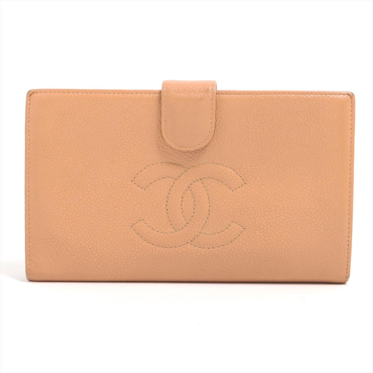 The Chanel CC Logo Caviar Skin Bi-fold Wallet in Brown Gold is a luxurious and timeless accessory that embodies the elegance of the Chanel brand. Crafted from high-quality caviar skin leather, known for its durability and distinctive texture, the
