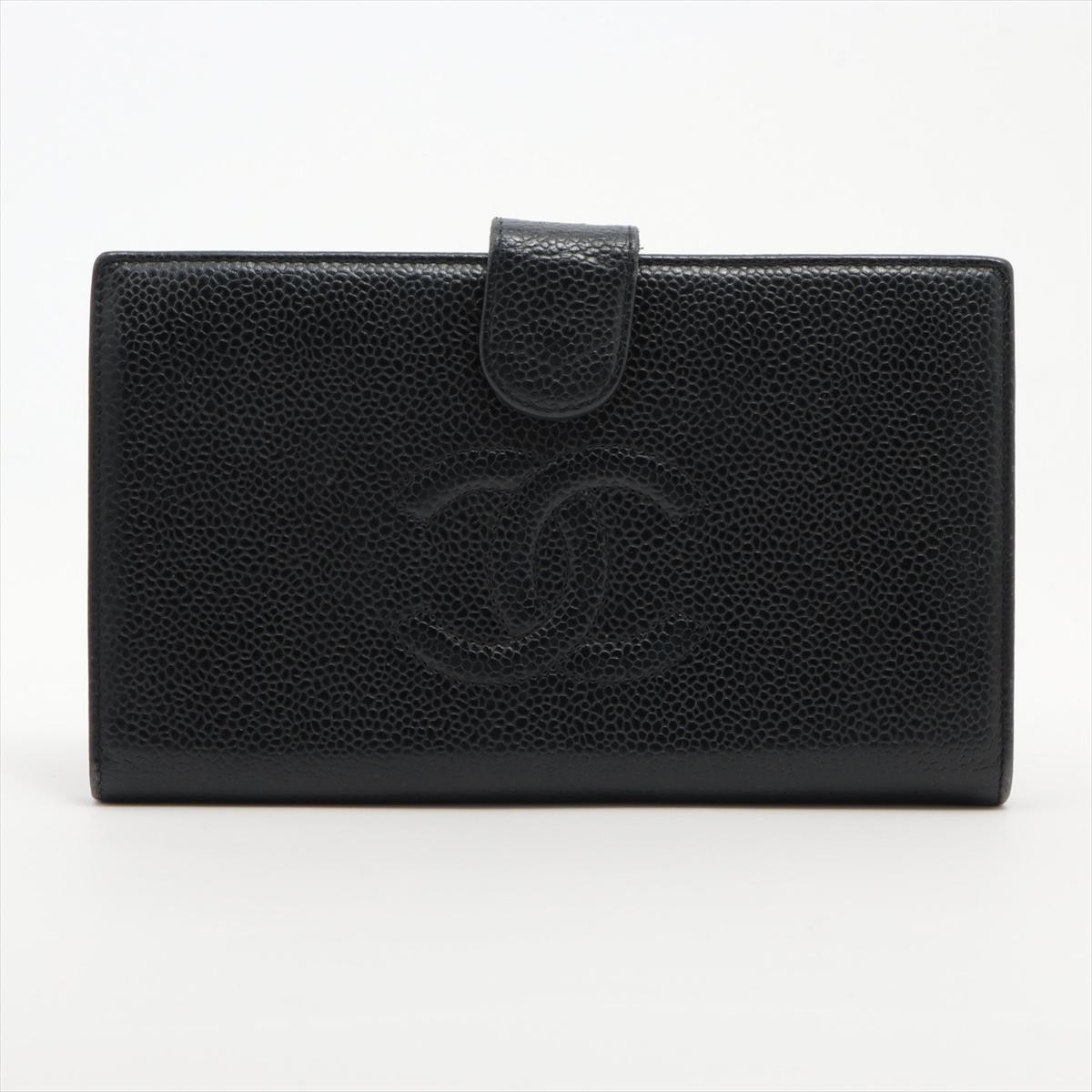 The Chanel CC Logo Caviar Skin Bi-fold Coin Card Wallet in Black is a sophisticated and timeless accessory that embodies the elegance of the Chanel brand. Crafted from luxurious caviar skin leather, the wallet features iconic CC logo embossed on the
