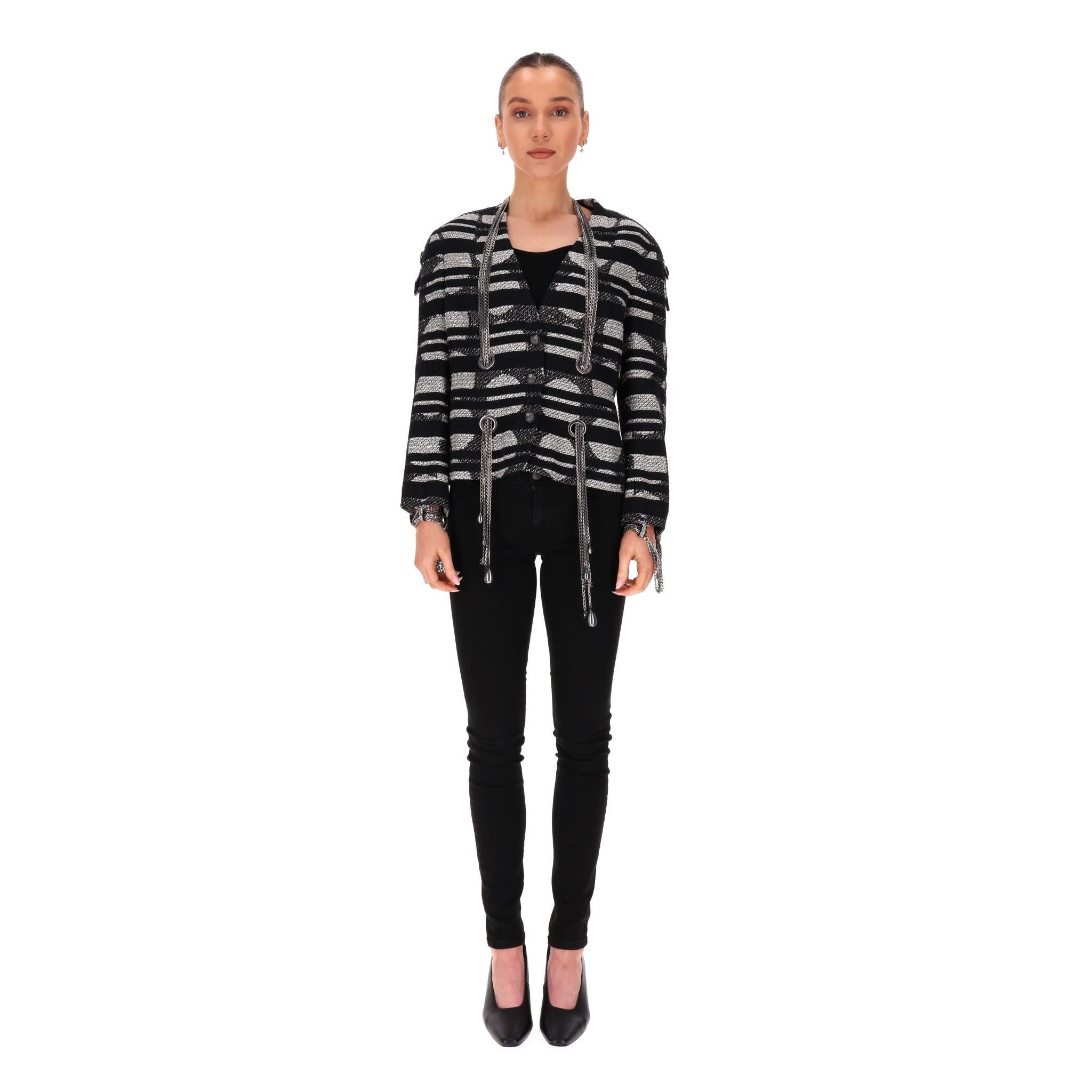 Chanel 'CC' Logo & Chain Detail Tweed Jacket

From 2008 Collection by Karl Lagerfeld is this black and metallic grey tweed jacket.

Designed with branded, ruthenium hardware with removable chains embellishment, detailed with dangling mini 'CC' logos