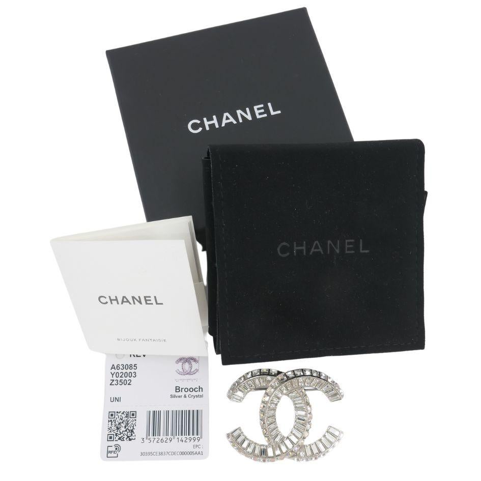 Authentic Chanel Silver Crystal CC Logo Brooch designed by the one and only Karl Lagerfeld. Comes with original box and tag. The pin is 2
