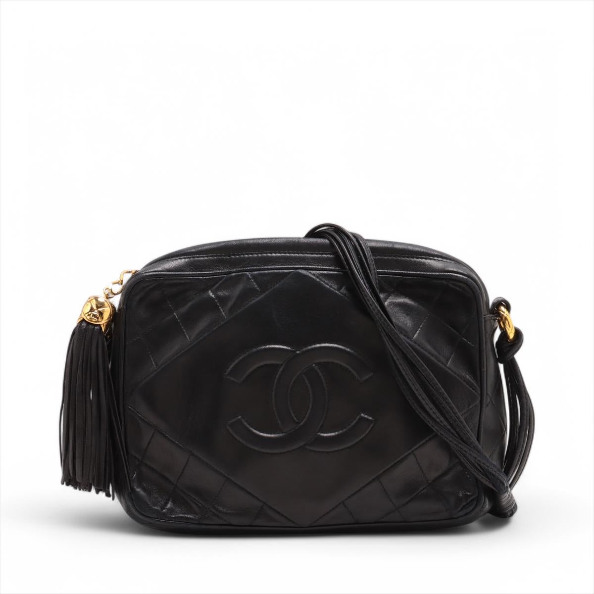 The Chanel CC Logo Matelassé Lambskin Tassel Camera Bag in black offers ample space in a compact design, combining elegance and practicality. Made from soft, quilted lambskin leather, it features the iconic CC logo on the front, adding a touch of