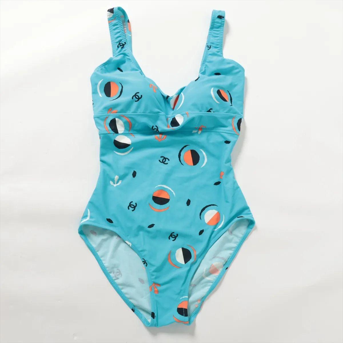 The Chanel CC Logo Nylon One-Piece Swimwear in light blue offers a chic and timeless take on beachwear. Crafted from smooth, high-quality nylon, the swimsuit provides a flattering fit with a comfortable stretch. The soft light blue hue enhances its