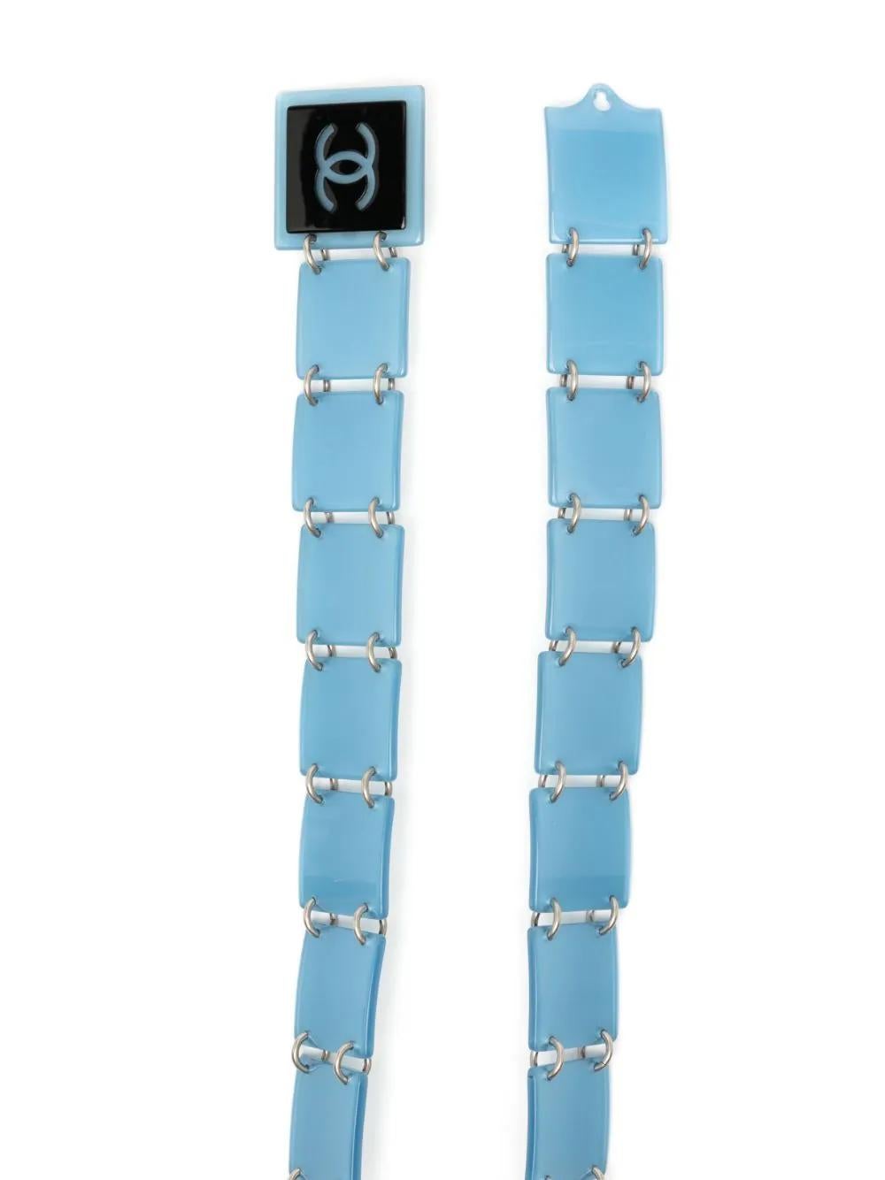 Add a touch of style to any ensemble with this vintage plexiglass Chanel belt. Showcasing articulated blue plaques linked together. The belt fastens using a hook closure. You would be forgiven for thinking this belt was actually for your jewellery
