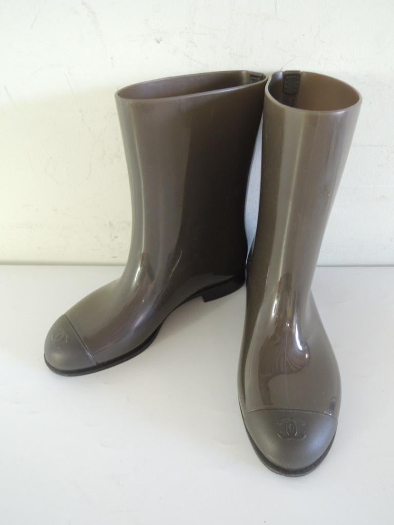 This is a pair of Chanel cap-toe rain boots with CC logo and quilted sole detail.

These are in good pre-owned condition. These have been worn and show a bit of scuffing in a couple of spots but it isn't especially noticeable while wearing. Overall