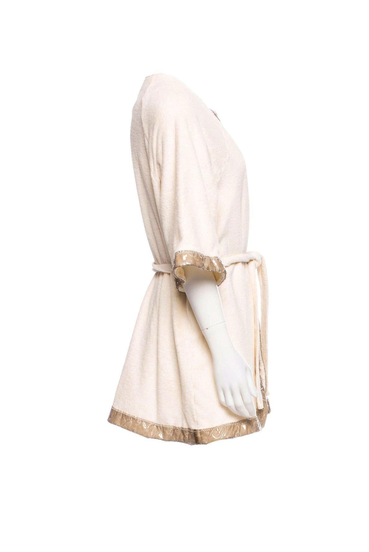 A great piece created by CHANEL
Stunning piece to wear at the pool, beach or at home
Chanel robe made of finest terrycloth
Contrast transparent trim featuring perforated interlocking CC patterns throughout 
Tie closure at waist
It has the famous CC