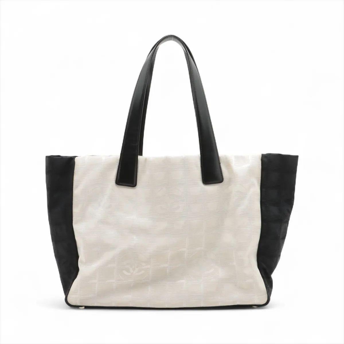 La borsa Chanel CC Logo Travel Line Tote Bag in beige e nero è un pezzo leggero ma sofisticato, progettato per una praticità elegante. Realizzata in nylon resistente con finiture in pelle, la tote presenta il motivo jacquard Travel Line tipico di