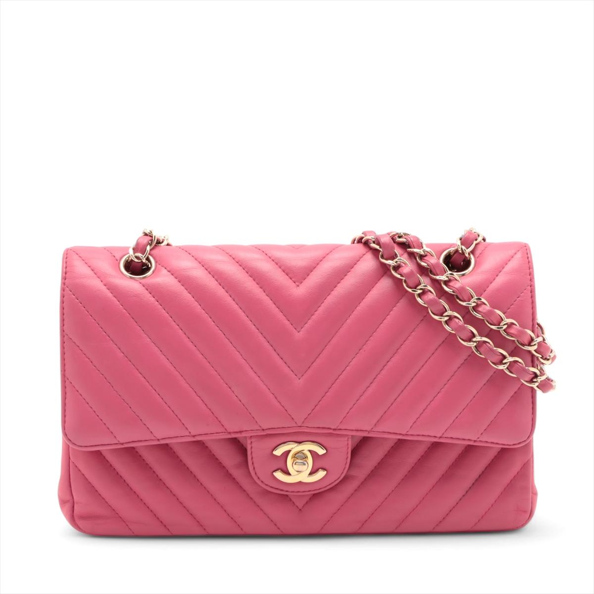 The Chanel CC Logo V-Stitch 25 Lambskin Double Flap Double Chain Bag in hot pink is a vibrant and sophisticated accessory that epitomizes the brand's timeless elegance. Crafted from luxurious lambskin leather, it features a distinctive V-stitch